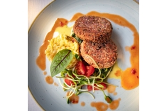 Image Plant-based patties served with vegetables and sauce